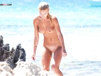 A lady enjoying the solitude of the dunes in a classic topless fashion.