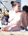 The feeling of the salt air on bare skin during a walk at a nude beach.