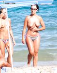 The feeling of the salt air on bare skin during a walk at a nude beach.