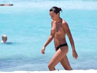 Walking the Shoreline at a Nude Beach with Surf Behind