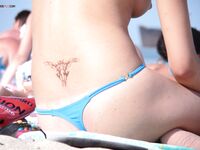 Clear-Sky Topless Sunbathing on a Warm Summer Beach Day