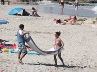 Despite cloudy weather and few people on the beach, my wife decided to have a little fun!.