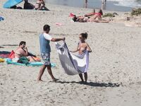 Despite cloudy weather and few people on the beach, my wife decided to have a little fun!.