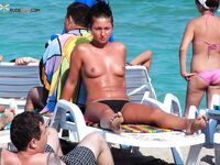 A lady enjoying the tranquility of the coast in a natural topless fashion. 3