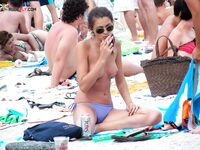 A lady enjoying the tranquility of the coast in a natural topless fashion. 3