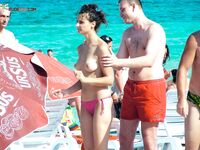 A lady enjoying the tranquility of the coast in a natural topless fashion. 3