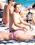 A model relaxing on the beach, perfectly at home in her own skin. 3