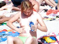 Celebrating the natural form: a lady relaxing topless against the backdrop of the blue horizon.