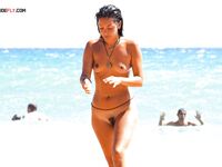 A collection of candid moments at a beach where being topless is the norm. 2