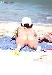 Cappellino da baseball al limitare dell'onda sulla spiaggia nuda