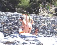Two Nudists Smiling on Towels in Cap and Bandana