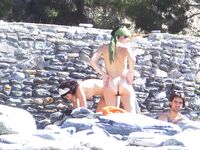 Two Nudists Smiling on Towels in Cap and Bandana