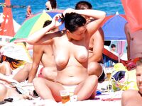 An Easy Topless Stroll Past Waves and Scattered Beach Chairs