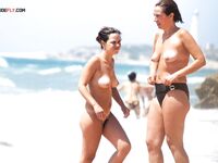 Embracing the European coastal tradition of topless summer relaxation. 2