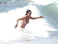 Embracing the European coastal tradition of topless summer relaxation. 2