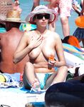 The elegance of a woman posing topless against the backdrop of the horizon.