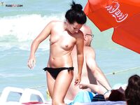 The elegance of a woman posing topless against the backdrop of the horizon.