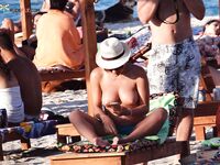 The simple life: bare feet in the sand and the sun on a topless chest.