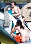 One Woman Topless in Denim Shorts at a Beach Bar