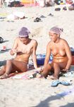 One Woman Topless in Denim Shorts at a Beach Bar