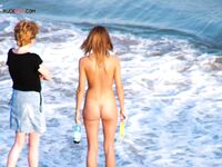 Denim Skirt and Long Hair on Wet Sand Beside Breaking Surf