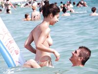 Wading Through Shallow Sea Water in Striped Bikini Bottoms