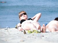One Nude Beach Visitor Wearing a Bright Orange Cap