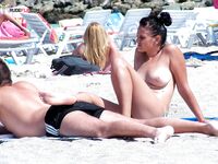Sandy Nude Beach Spot with a Water Bottle Nearby