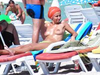 Sandy Nude Beach Spot with a Water Bottle Nearby