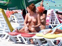 Sandy Nude Beach Spot with a Water Bottle Nearby