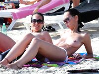 Rainbow Towel Recline and Oversized Shades on the Topless Beach