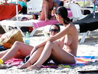 Rainbow Towel Recline and Oversized Shades on the Topless Beach