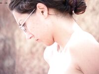 Sitting Against Red Rocks at a Nude Beach