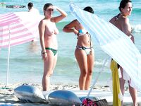 Soft sand and golden skin: a peaceful morning spent in a classic topless fashion.