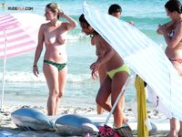 Soft sand and golden skin: a peaceful morning spent in a classic topless fashion.