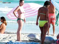 Soft sand and golden skin: a peaceful morning spent in a classic topless fashion.