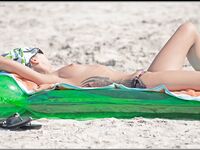 Sitting by a Black Bag at a Nude Beach