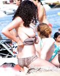 Posing with confidence in a state of total, liberated nudity by the sea. 2