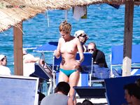 A lady enjoying a peaceful moment at a secluded, clothing-optional cove. 4