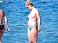 A lady enjoying a peaceful moment at a secluded, clothing-optional cove. 4