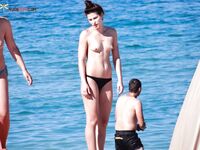 A lady enjoying a peaceful moment at a secluded, clothing-optional cove. 4