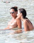 . The artistic silhouette of a topless model against the sparkling blue sea. 2