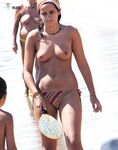. The artistic silhouette of a topless model against the sparkling blue sea. 2