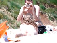 He Frames a Sunlit Shot of Her on the Sandy Nude Beach
