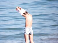 Embracing the elements: salt air, warm light, and the liberty of being topless. 2