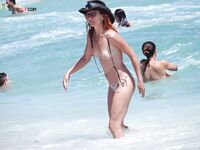 Water-Flecked Skin and Wet Hair Crossing Warm Nude Beach Sand