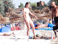 Water-Flecked Skin and Wet Hair Crossing Warm Nude Beach Sand