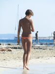 Gentle Waves Lap at Her Feet Along a Natural Shoreline