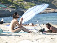 Gentle Waves Lap at Her Feet Along a Natural Shoreline