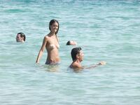 Gentle Waves Lap at Her Feet Along a Natural Shoreline